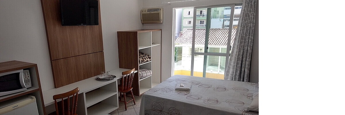 Internal area of the suite showing the TV on the panel and the balcony